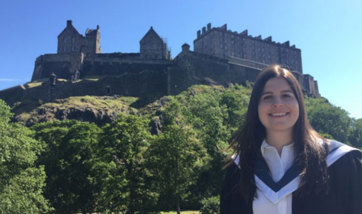 Alexia Mitchell standing next to Edinburgh Castle
