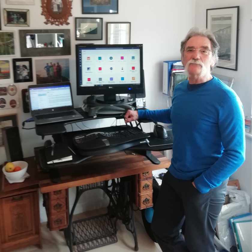 Barry Dickson standing next to an ergonomic workstation