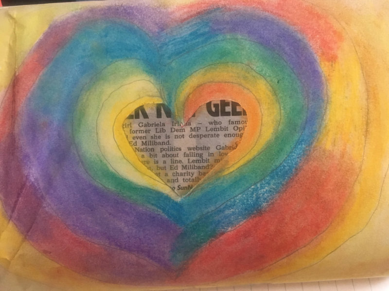 A rainbow heart with a paper cutting in the middle