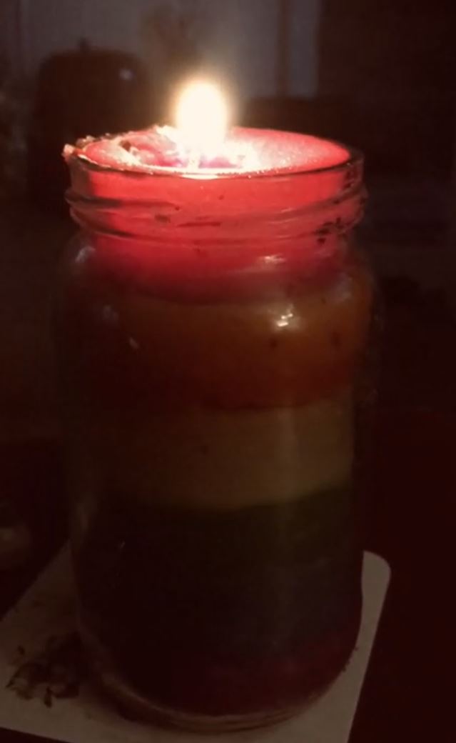 A rainbow candle burning bright