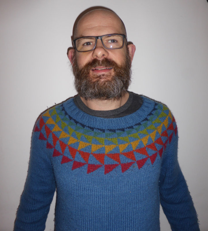 QMU professor Steve Darling wearing a rainbow jumper