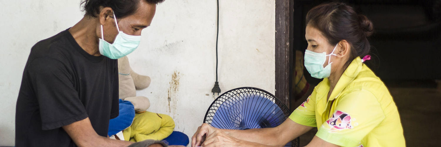 A nurse administering TB treatment to a patient