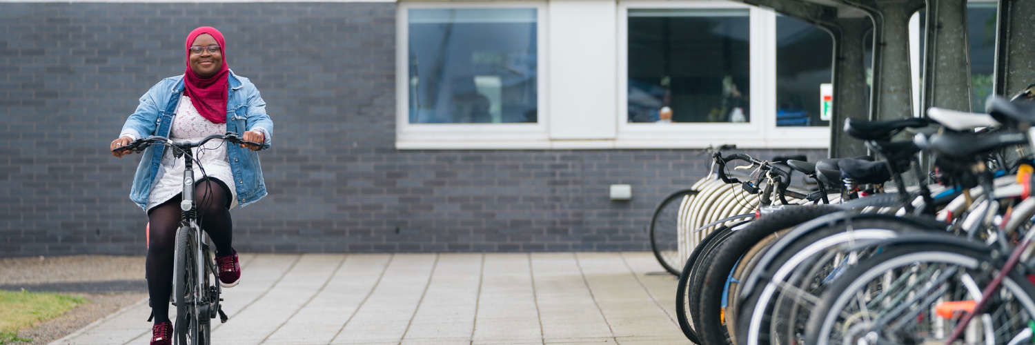 A student cycling at Queen Margaret University, Edinburgh