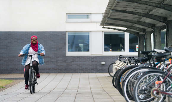 A student cycling at Queen Margaret University, Edinburgh