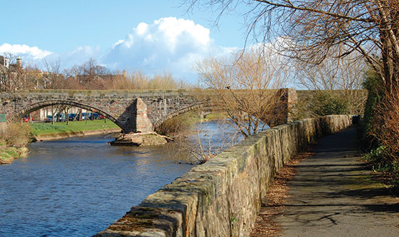 A stone bridge in Musselburgh on a sunny day