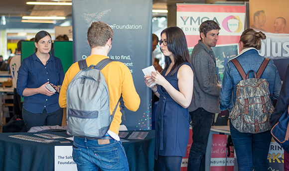A group of students at a fair in Queen Margaret University, Edinburgh