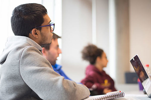 A small group of Queen Margaret University students listening in class