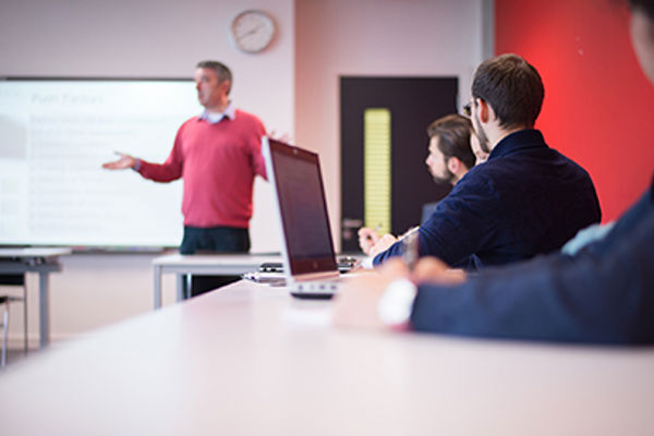 A small group of Queen Margaret University students listening in class