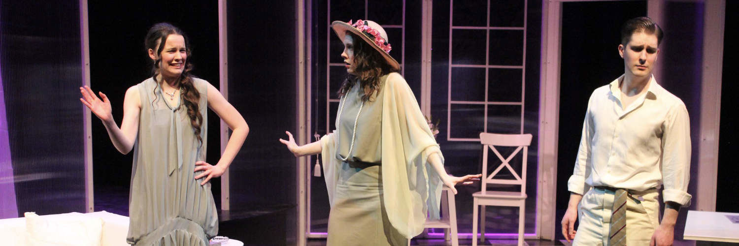Three Queen Margaret University students acting on stage