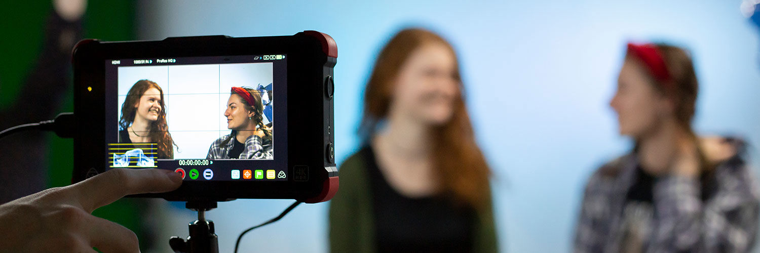 Two Queen Margaret University students being filmed in a sound studio
