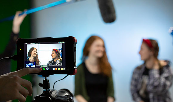 Two Queen Margaret University students being filmed in a sound studio