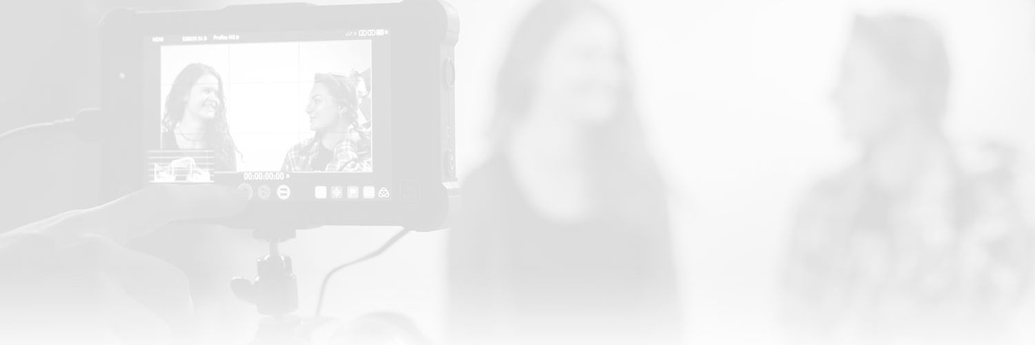 A faded image of two students talking on film