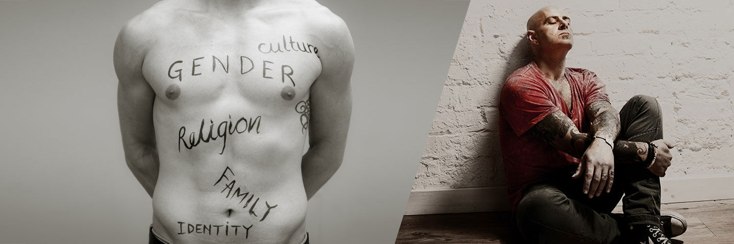 Torso with sociology themes written in pen and a person with closed eyes on floor leaning against a brick wall