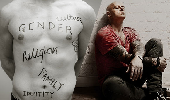 Sociology collage: A bare torso covered in written words "Gender", "Culture", "Religion", "Family" and "Identity" and a man sitting on the floor, leaning against a brick wall