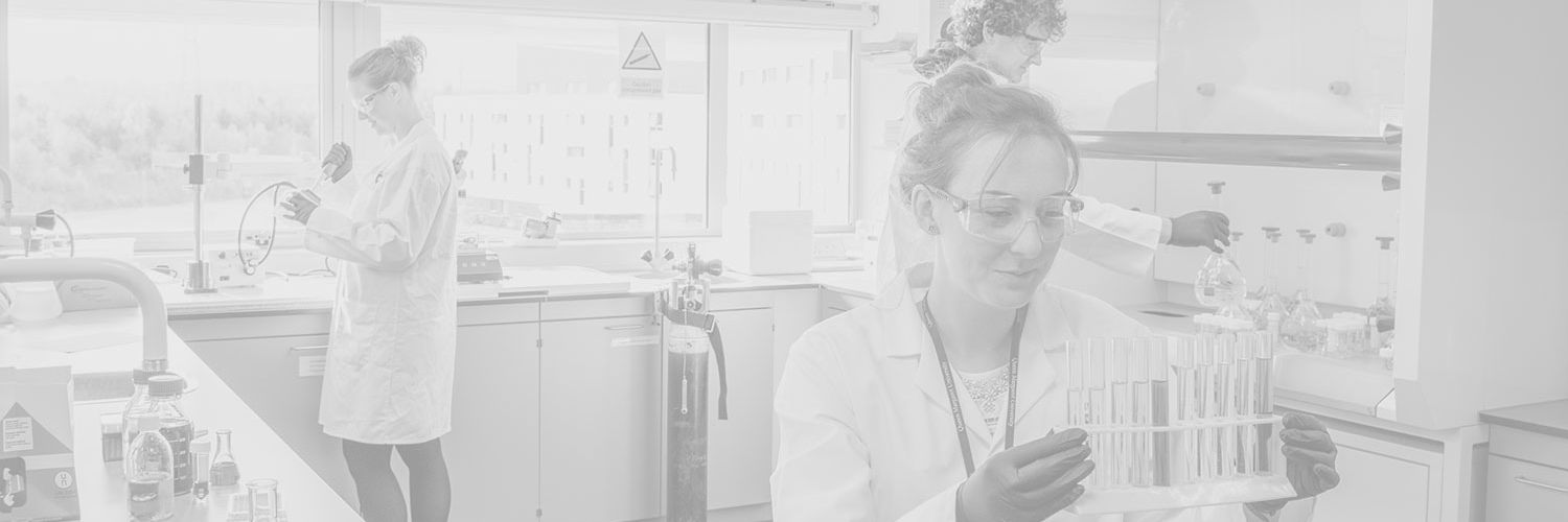 Faded image of Dietetics and Nutrition students in a lab