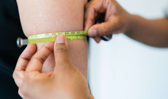 A nurse measuring the upper arm