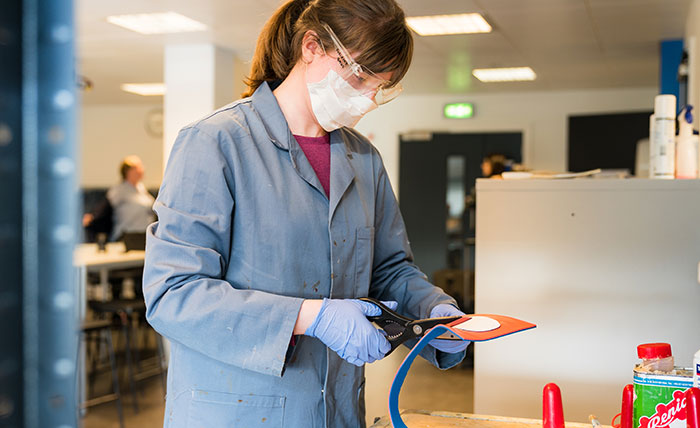 A Queen Margaret University student making shoe insoles