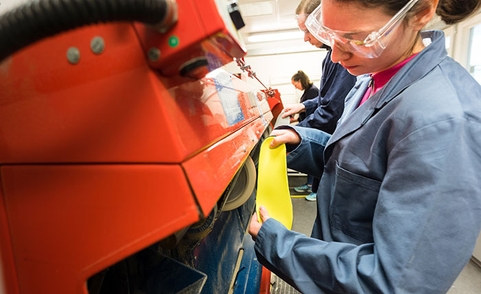 A Queen Margaret University student making shoe insoles