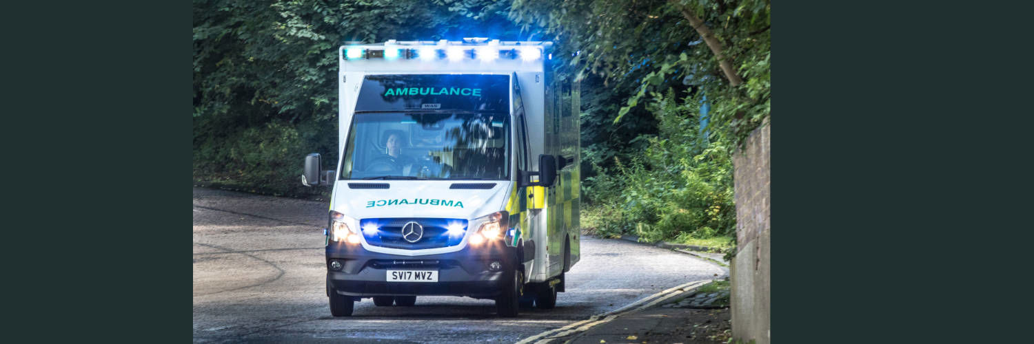 An ambulance driving with its lights on