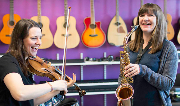QMU students in music workshop facility playing instruments