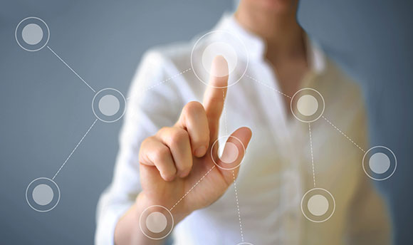 A woman holding her finger up edited to look as though she is selecting a dot on a glass screen