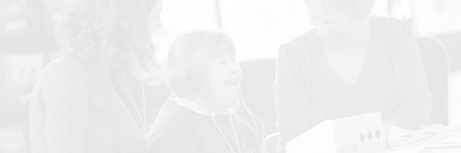 Faded image of a young girl with Downs Syndrome using the speech & language therapy equipment