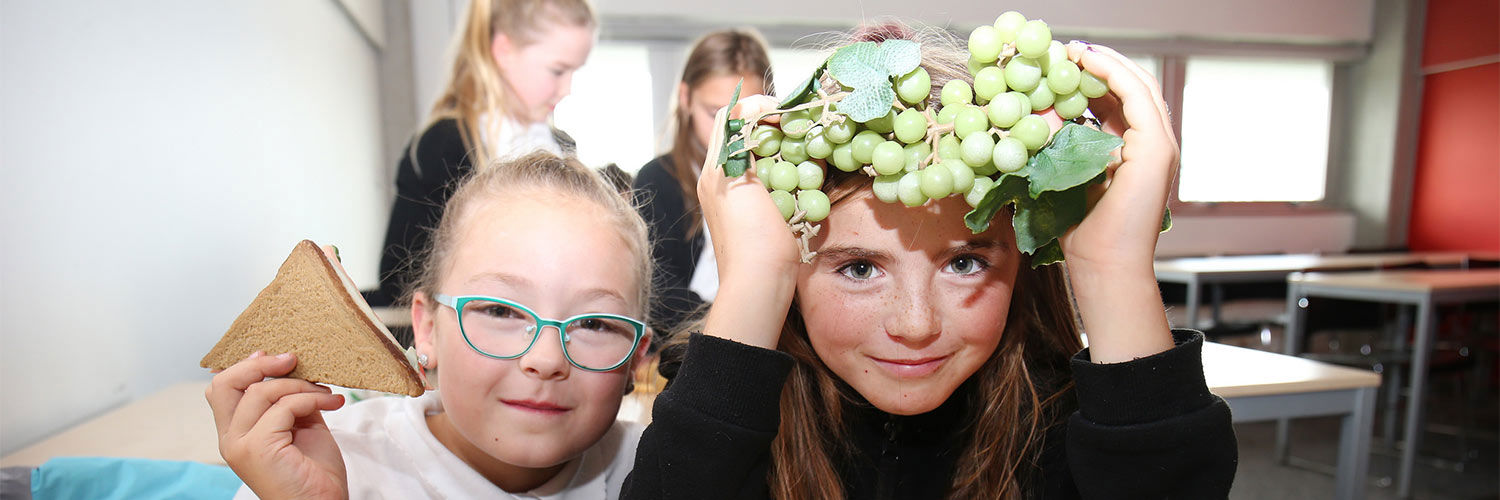 Two young girls posing with healthy fresh fruit