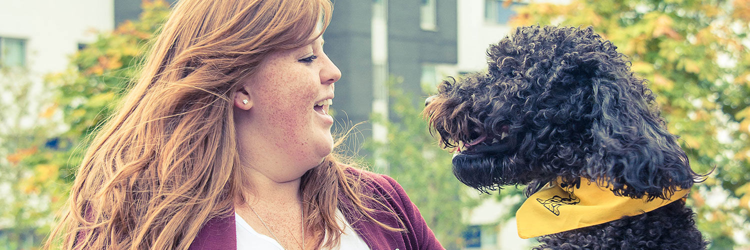 QMU student with Rocco the therapy dog