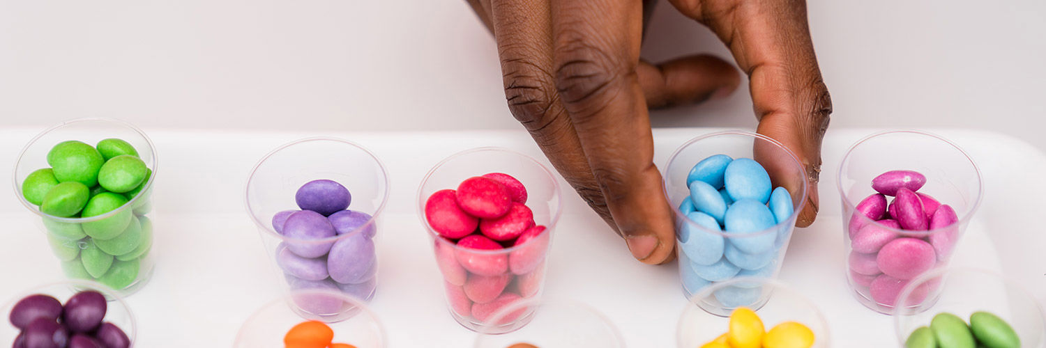 A hand reaching for a food sample