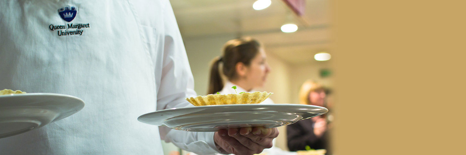 A waiter in QMU whites