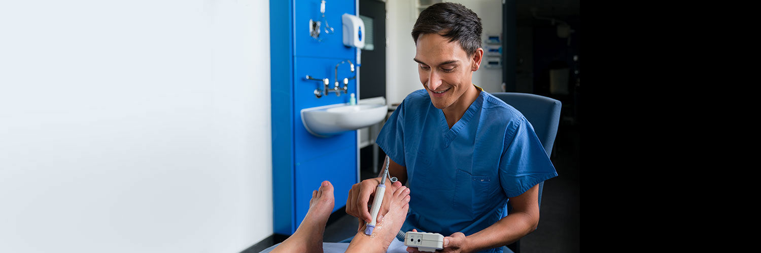 Joseph attending to a podiatry patient