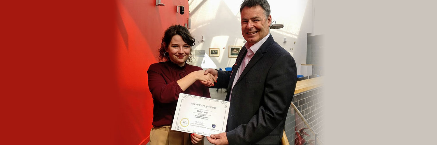 Mel Fraser receiving her award