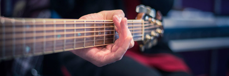 A close up of someone holding a guitar