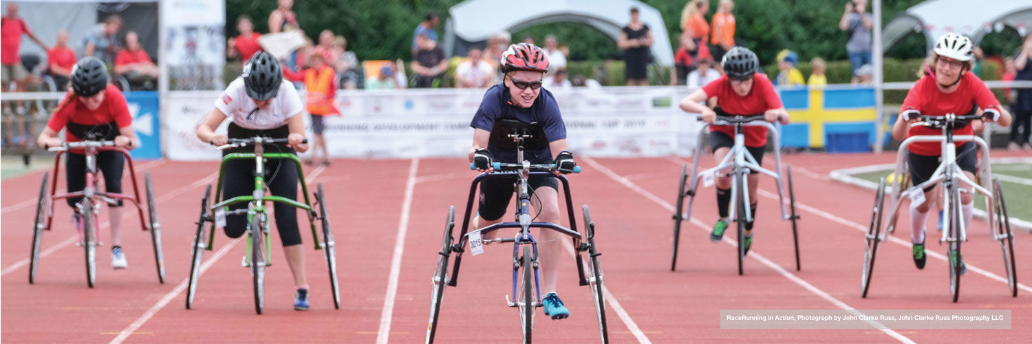 Athletes in wheelchairs racing on the track 
