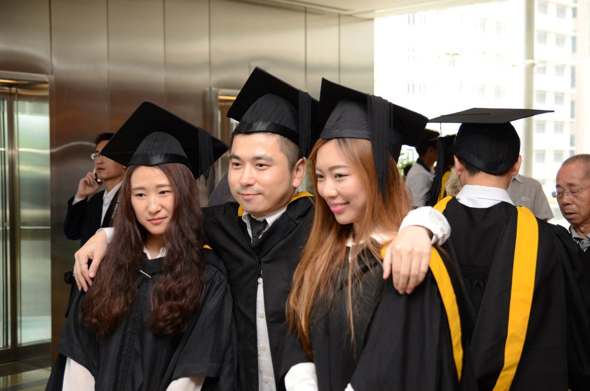 A group of students posing for a photo in their graduation caps and gowns