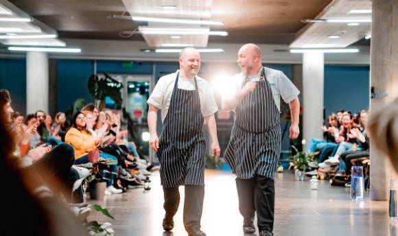 Two chefs showing off their whites at QMU Feelgood Fashion Show