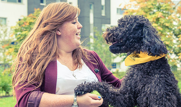 QMU student with Rocco the therapy dog