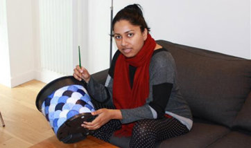 Prema Howard, holding a bucket she appears to be painting