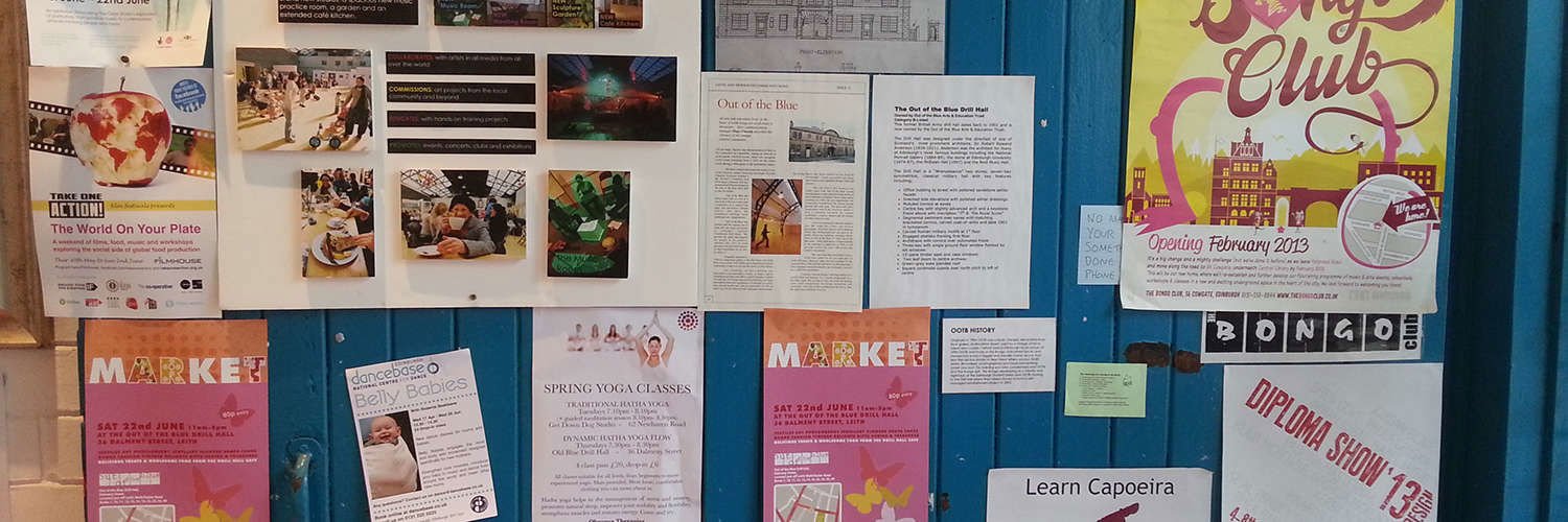 A pin board of posters and adverts