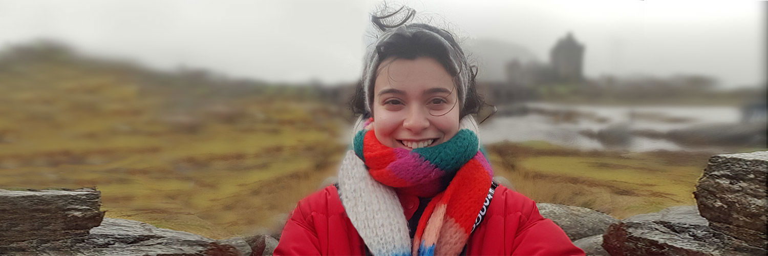 Yeliz taking a self portrait outside in a warm jacket