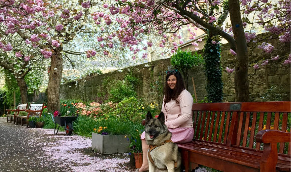 Charlotte Cransten sitting underneath the cherry blossoms