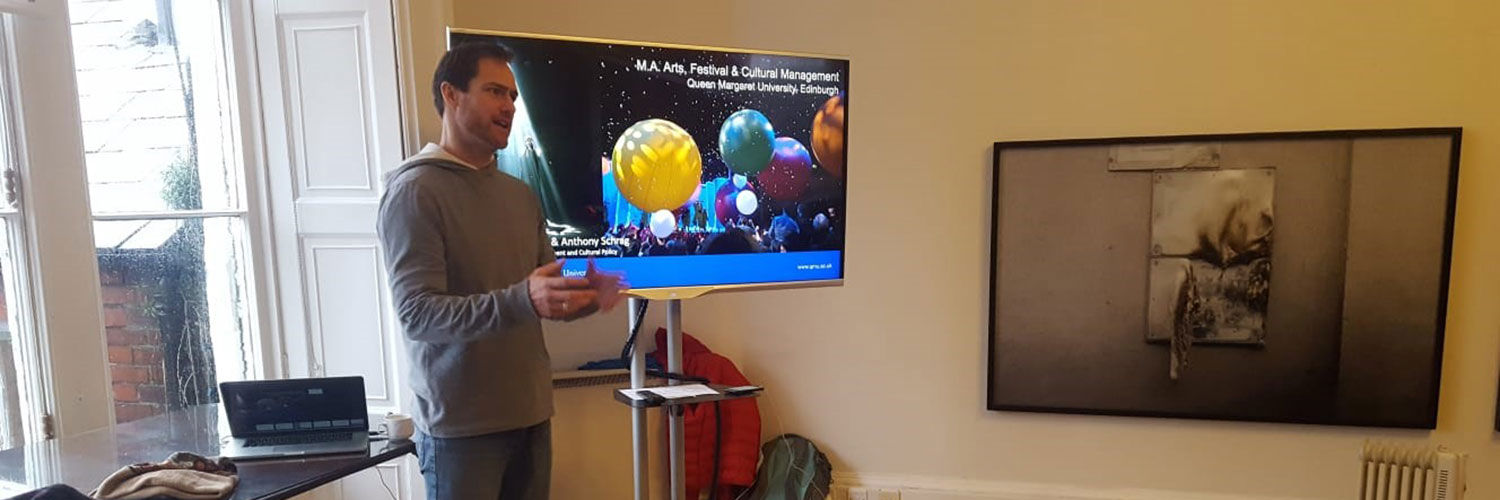 A QMU student conducting a presentation