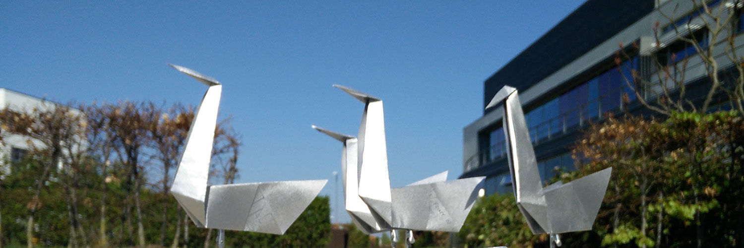 Large silver sculptures of origami swans