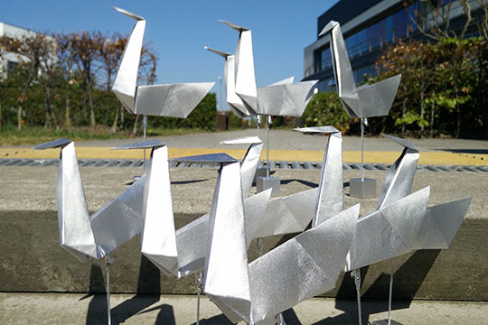 Large silver sculptures of origami swans