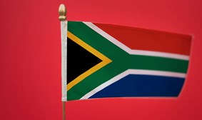 South African flag set against a solid red background