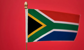 South African flag set against a solid red background