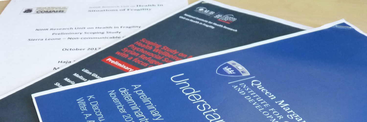 Some printed papers with the QMU logo printed on the front page