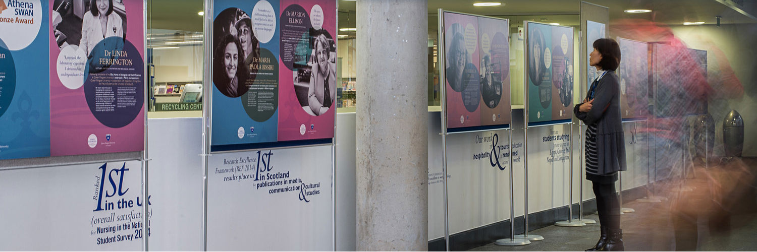 Kyoko Jardine reading a research display at Queen Margaret University