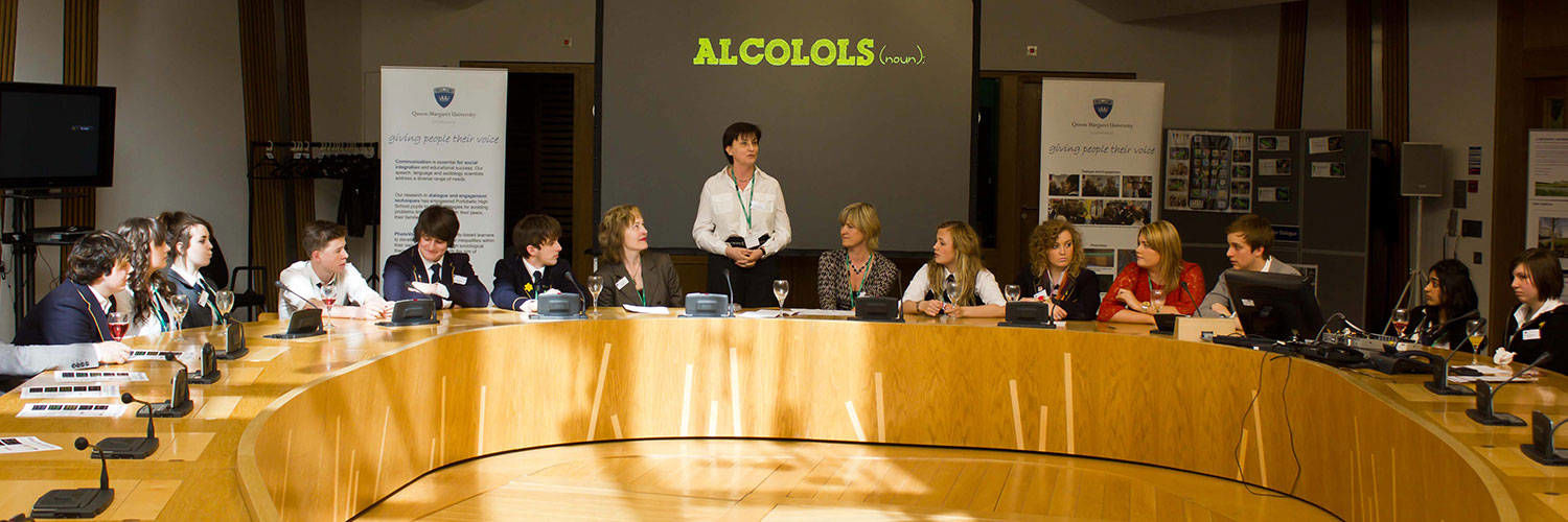 A panel being led with a large screen showing information relating to alcohol