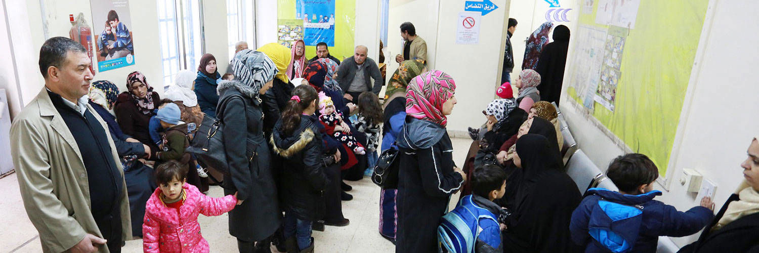 A busy waiting room full of adults and children